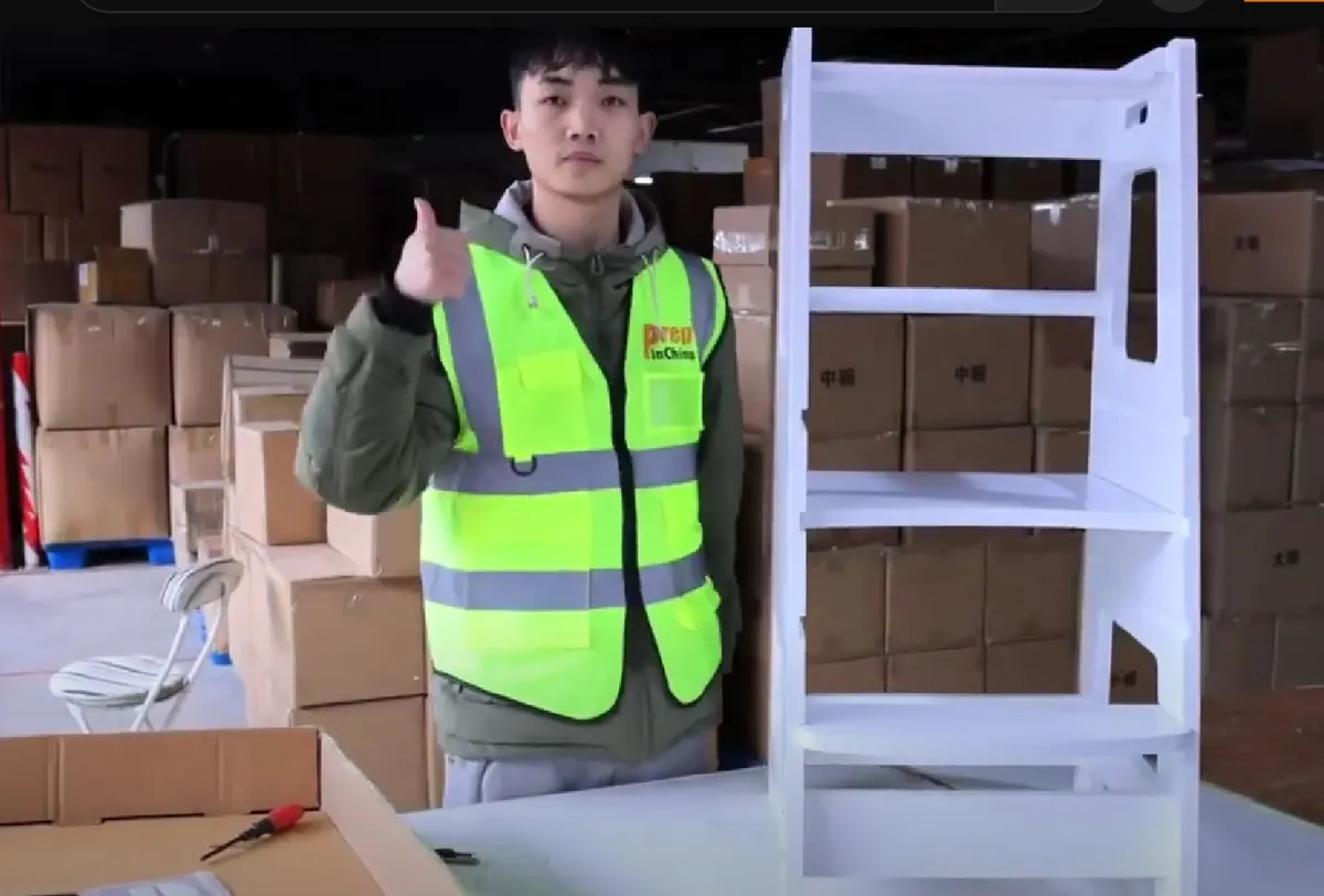Inspector giving a thumbs-up beside a finished product in a warehouse check area.